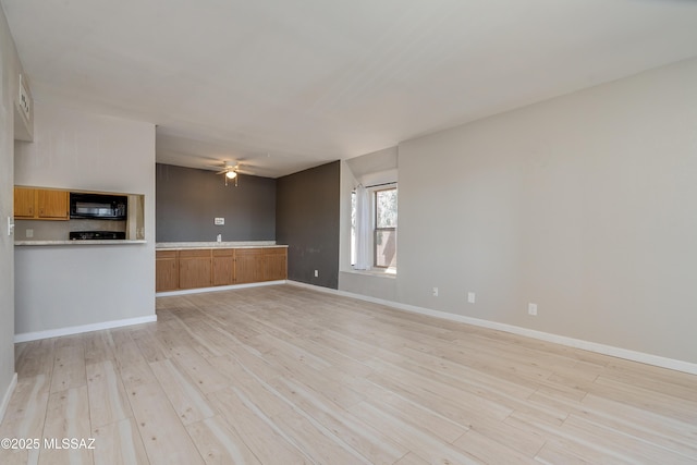 unfurnished living room featuring light hardwood / wood-style floors and ceiling fan