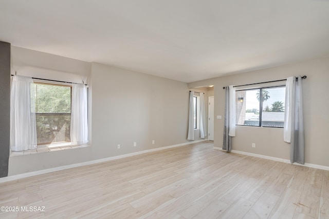 empty room with a healthy amount of sunlight and light wood-type flooring