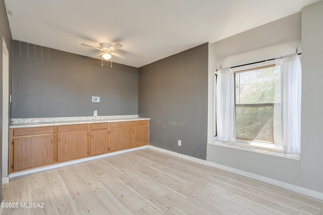 spare room featuring ceiling fan and light hardwood / wood-style floors