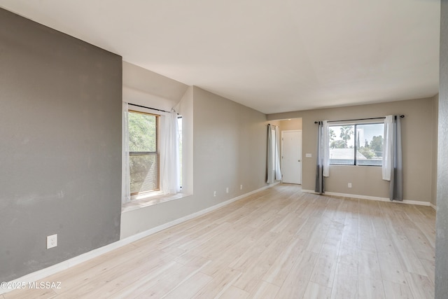 spare room featuring light wood-type flooring