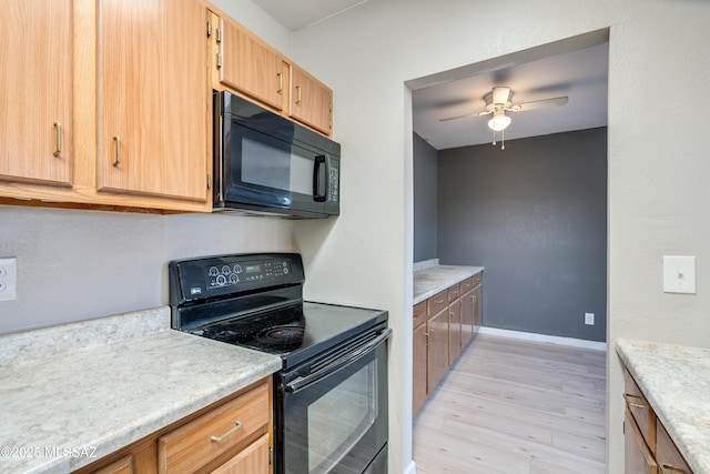 kitchen featuring black appliances, light hardwood / wood-style floors, and ceiling fan