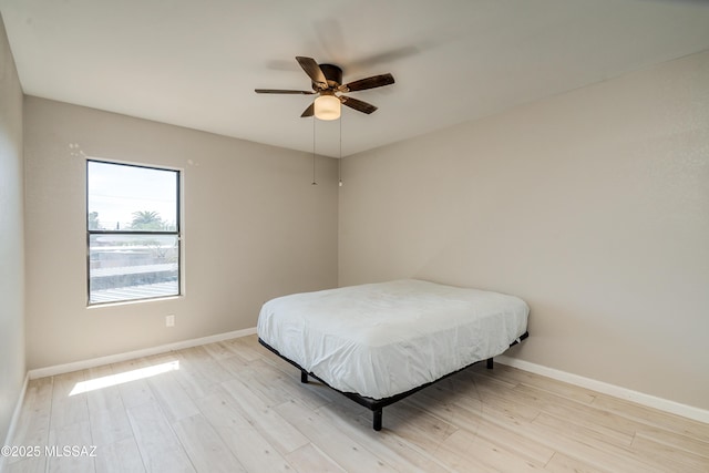 bedroom with ceiling fan and light wood-type flooring