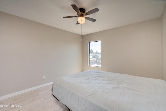 bedroom with ceiling fan and light hardwood / wood-style floors