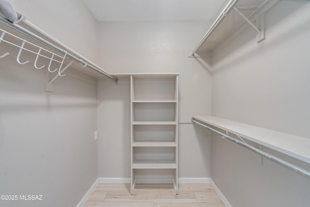 spacious closet featuring light hardwood / wood-style flooring