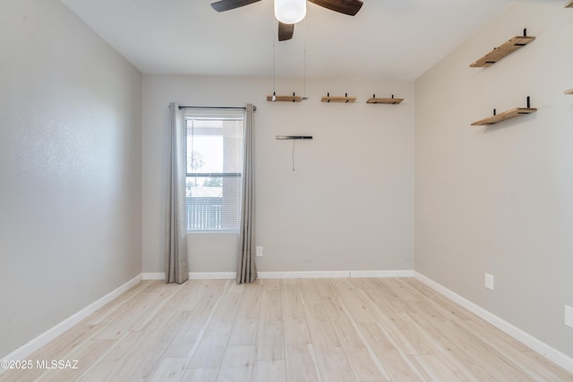 empty room with ceiling fan and light hardwood / wood-style floors