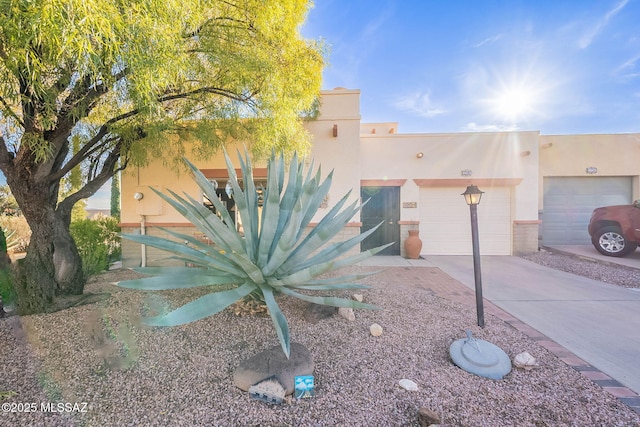 pueblo-style home with a garage