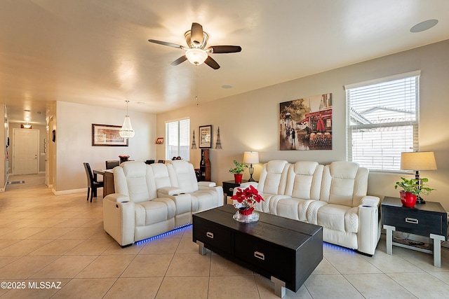 living room featuring light tile patterned flooring and ceiling fan