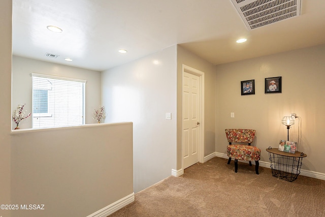 sitting room featuring light colored carpet