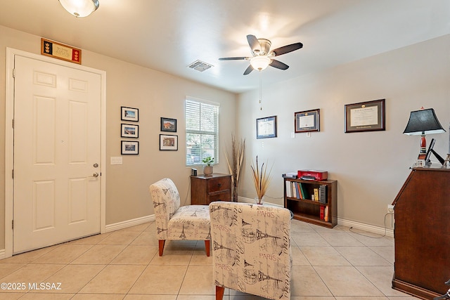 sitting room featuring light tile patterned floors and ceiling fan