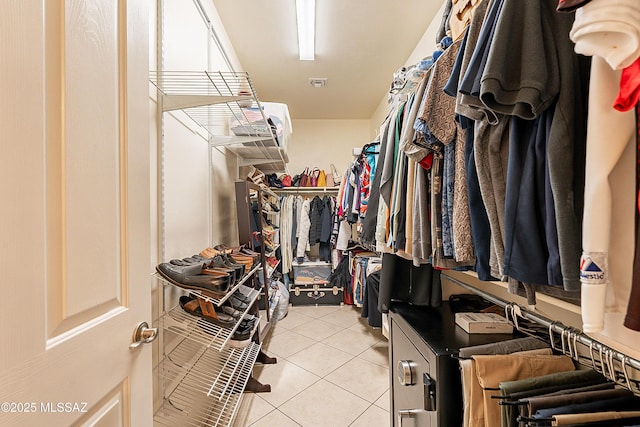 spacious closet featuring light tile patterned floors