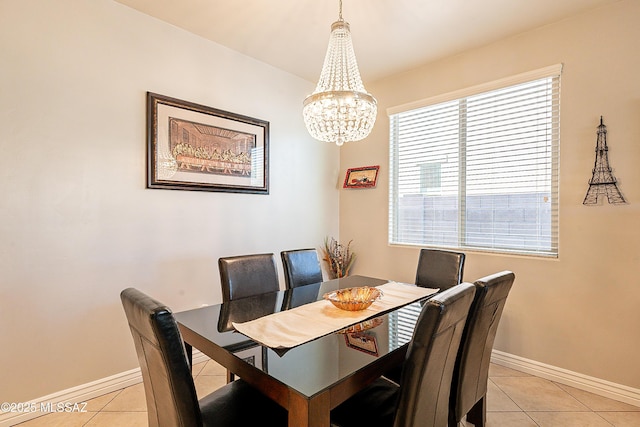 tiled dining area with a chandelier