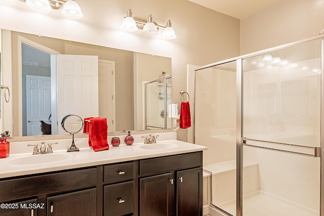 bathroom with vanity and a shower with door