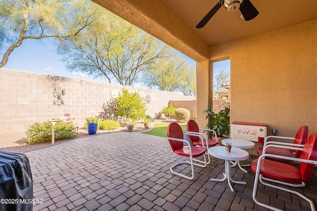 view of patio with grilling area and ceiling fan