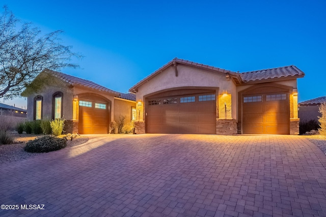 mediterranean / spanish house with a garage