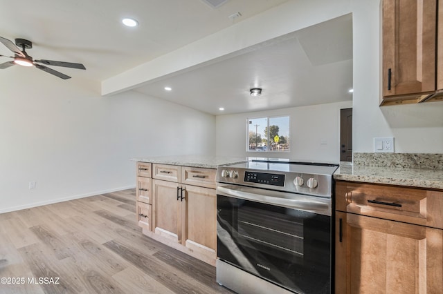 kitchen featuring ceiling fan, stainless steel range with electric stovetop, light stone countertops, beamed ceiling, and light wood-type flooring