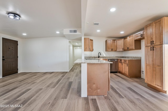 kitchen featuring light stone countertops, sink, stainless steel dishwasher, and light hardwood / wood-style floors