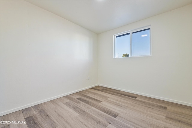 spare room featuring light hardwood / wood-style floors