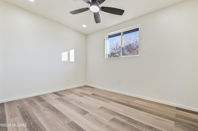 empty room featuring ceiling fan and light hardwood / wood-style floors