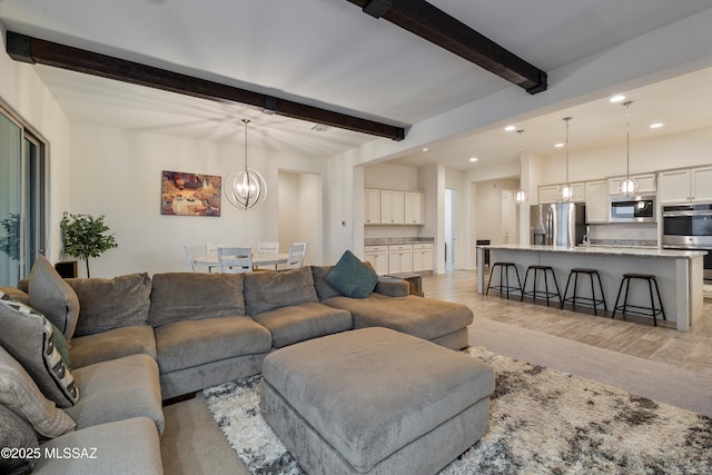 living area featuring a chandelier, recessed lighting, beam ceiling, and light wood finished floors