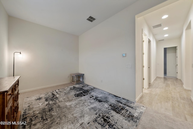 empty room featuring recessed lighting, light colored carpet, visible vents, and baseboards