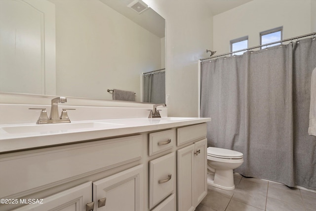 full bathroom featuring shower / bath combination with curtain, vanity, tile patterned floors, and toilet