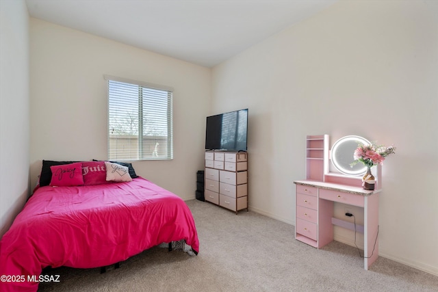 bedroom featuring baseboards and light colored carpet