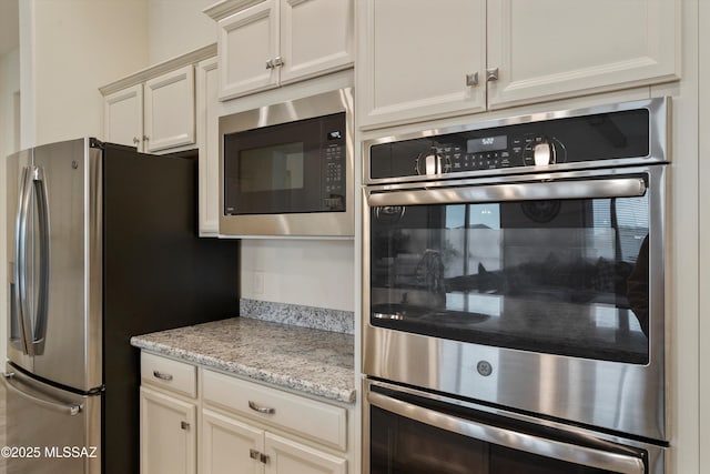 kitchen featuring light stone countertops and appliances with stainless steel finishes