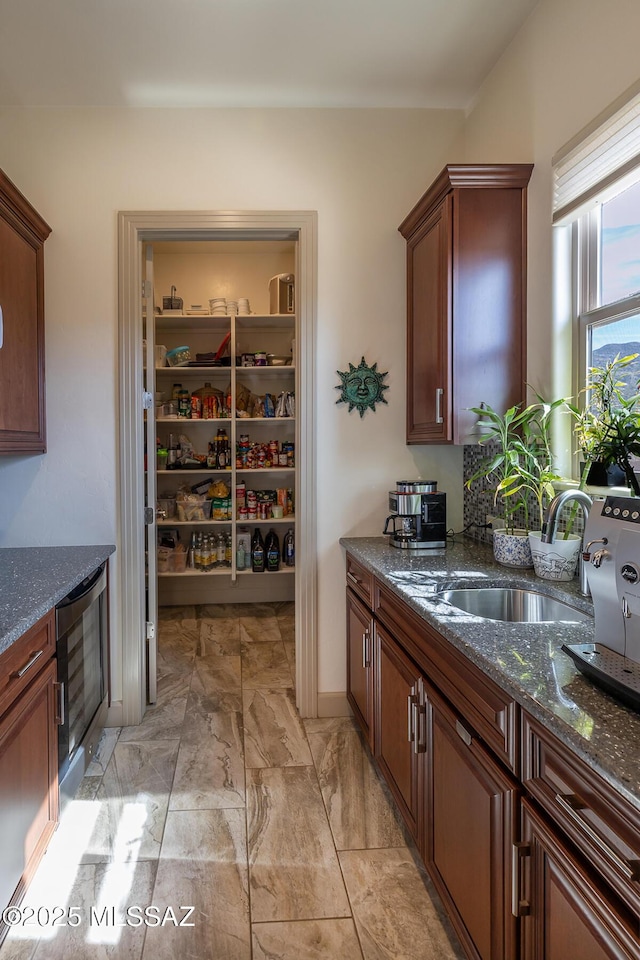 pantry featuring wine cooler and a sink