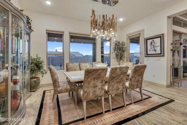 dining space with a chandelier, marble finish floor, recessed lighting, and baseboards