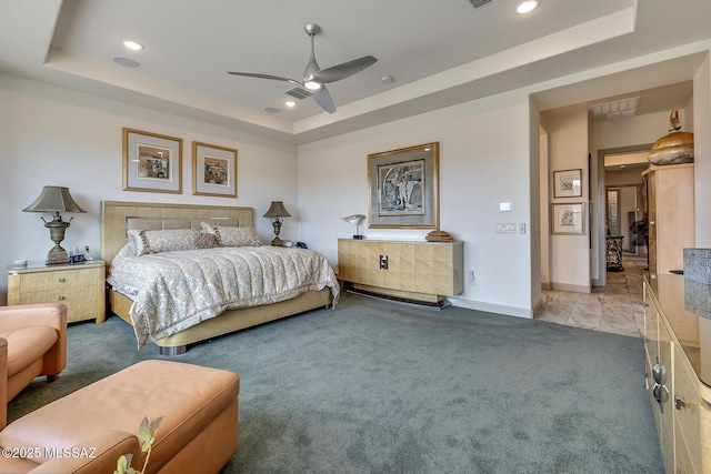 bedroom featuring carpet floors, a tray ceiling, and recessed lighting