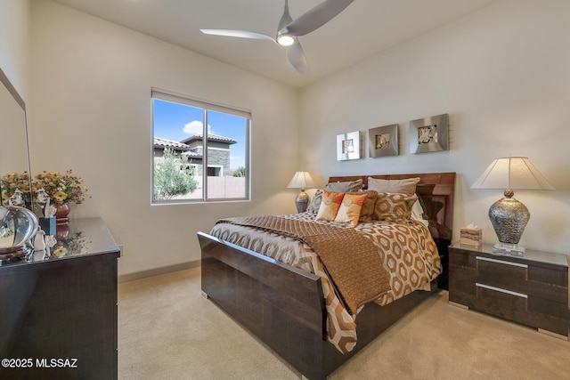 bedroom with baseboards, a ceiling fan, and light colored carpet