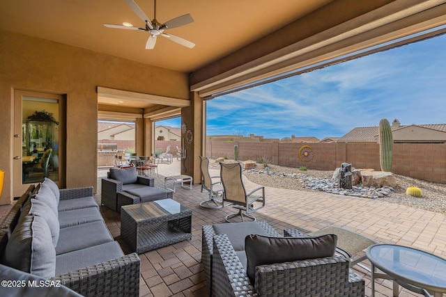 view of patio / terrace with ceiling fan, a fenced backyard, and an outdoor living space