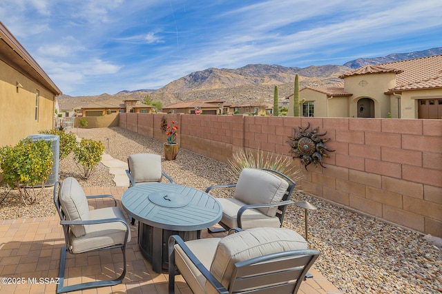 view of patio / terrace featuring a residential view, a fenced backyard, and a mountain view