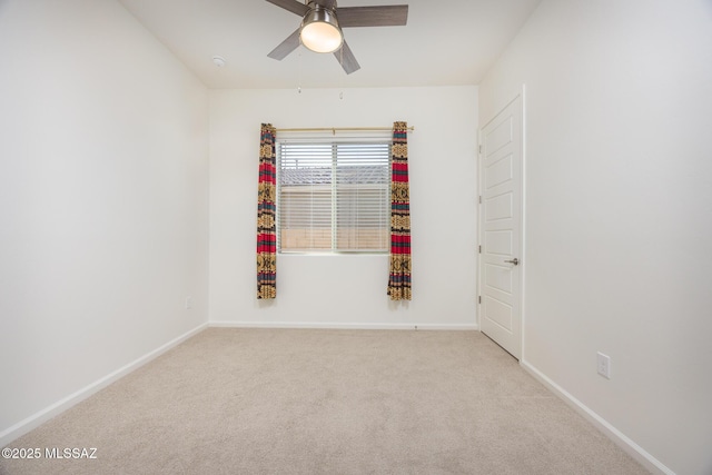 unfurnished room featuring light carpet and ceiling fan