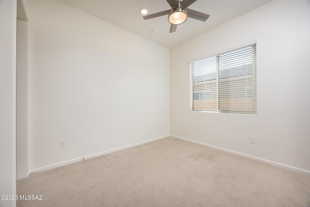 carpeted empty room featuring ceiling fan