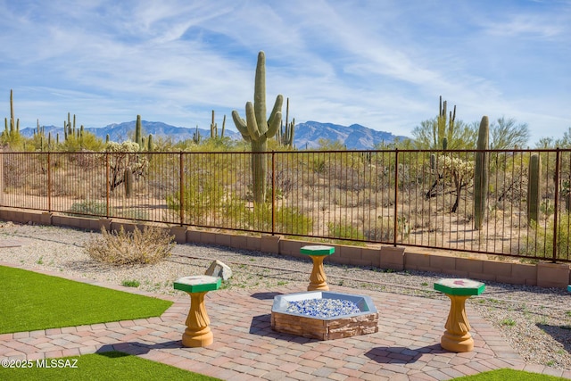 view of patio featuring a mountain view and an outdoor fire pit