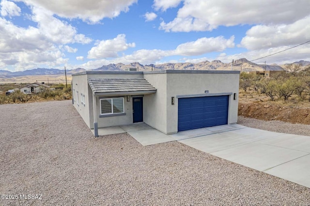 view of front facade with a garage and a mountain view