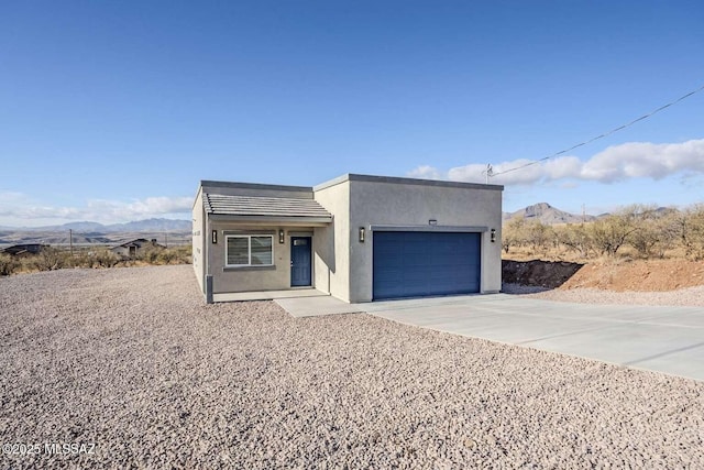 view of front of home featuring a garage and a mountain view