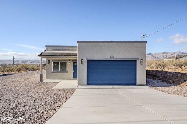 view of front of property featuring a mountain view and a garage