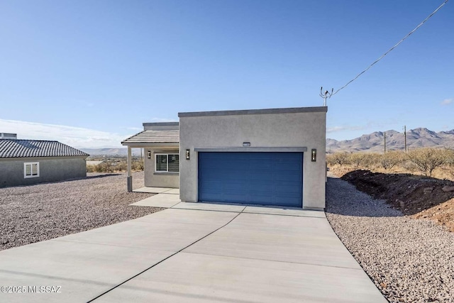 view of front of home with a mountain view and a garage