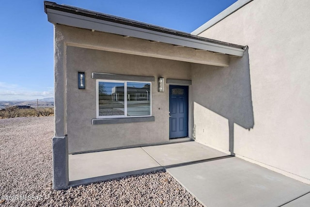 property entrance featuring a patio area