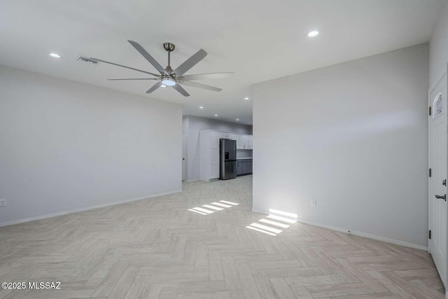 empty room featuring ceiling fan and light parquet flooring