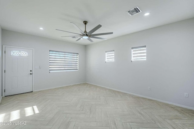 empty room featuring ceiling fan and light parquet flooring