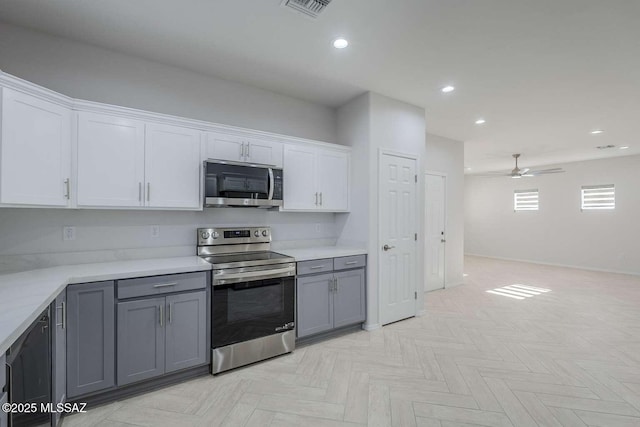 kitchen with white cabinetry, appliances with stainless steel finishes, gray cabinets, and light parquet floors