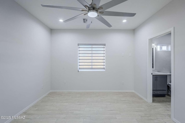 empty room with ceiling fan and light wood-type flooring