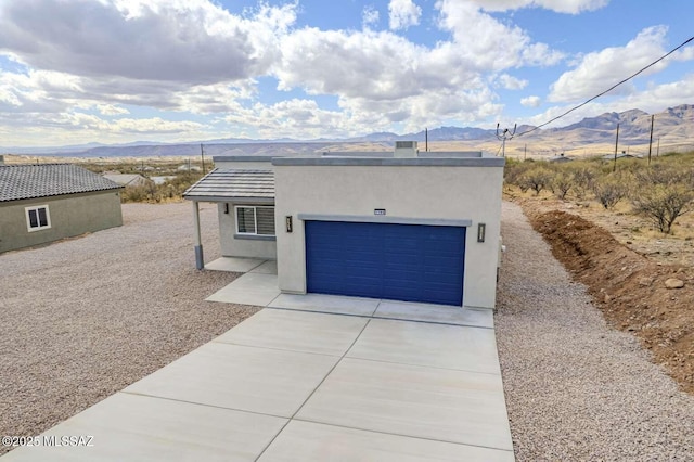 view of front of home with a garage and a mountain view