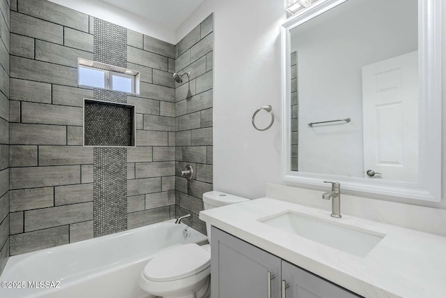 full bathroom with vanity, toilet, and tiled shower / bath combo