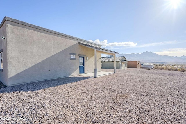 back of house featuring a mountain view