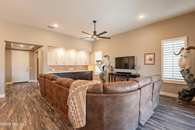 living room with dark hardwood / wood-style floors and ceiling fan