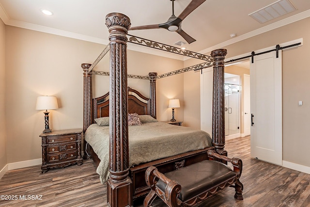 bedroom featuring crown molding, a barn door, ceiling fan, and hardwood / wood-style flooring